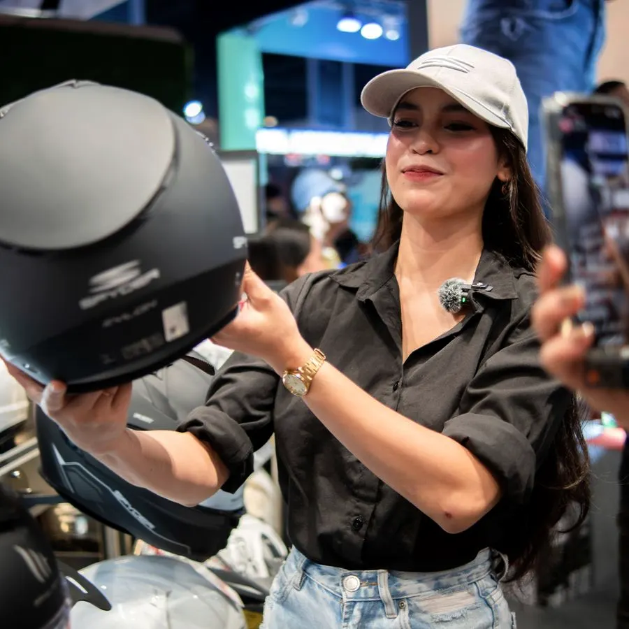 Showing a helmet to a customer at an event