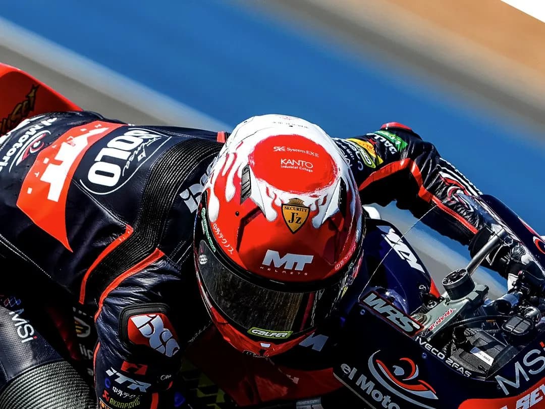 A Moto3 rider in an MT Helmets race helmet, leaned over at the Thai Grand Prix