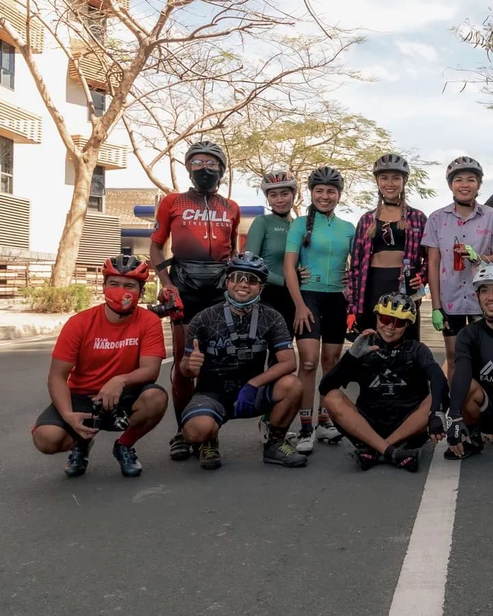 A cycling group stopped for a photo