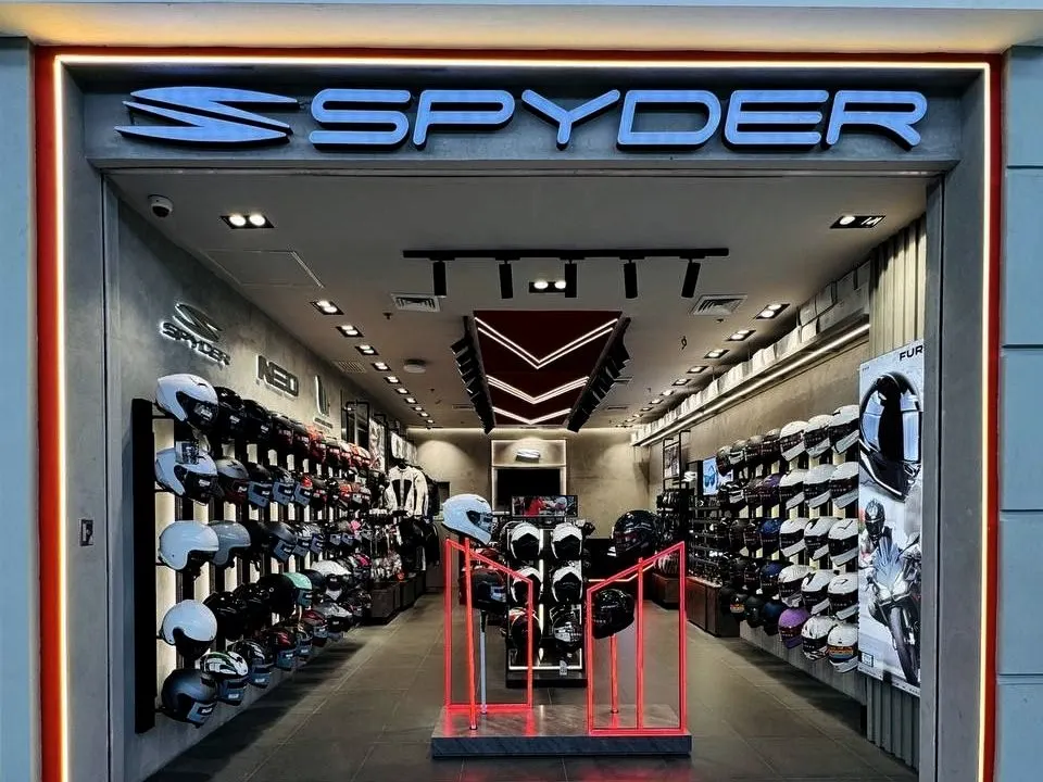 The Spyder concept store front, lit sign over the helmet wall